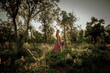 © Cavan Images - young woman in the middle of a forest in long summer dress
