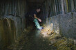 © Hennadii - The guy in the underground tunnel inside old sewer shaft