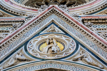 Cathedral Santa Maria del Fiore (or Duomo di Firenze), was built between 1296 and 1436. Cathedral is one of largest in world. Architectural fragments of front facade. Piazza del Duomo, Florence, Italy