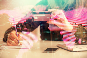 Multi exposure of woman on-line shopping holding a credit card and financial theme drawing. Business E-commerce concept.