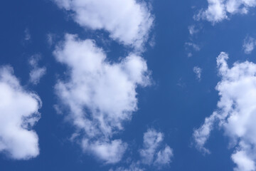 Dark blue sky with white fluffy soft clouds. Heaven.