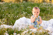© Тимур Конев - Cute little funny baby child sitting in chamomile field