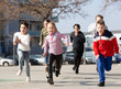 © JackF - Kids spending time together outdoors running on square at warm spring day