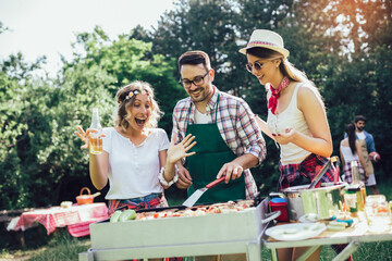 Friends having fun in nature doing bbq