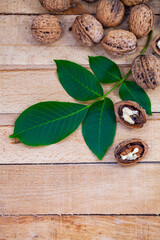 Wall Mural - Walnuts and leaves on a wooden table.