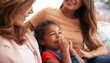 © Monkey Business - Multi-Generation Female Hispanic Family Relaxing On Sofa At Home