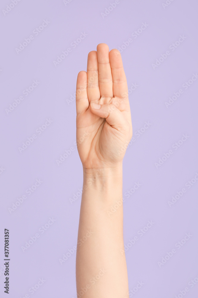 Hand showing letter B on color background. Sign language alphabet