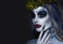 Portrait Of A Horrible Scary Corpse Bride In Wreath With Dead Flowers, Halloween Makeup And Long Manicure.Design Of Nails
