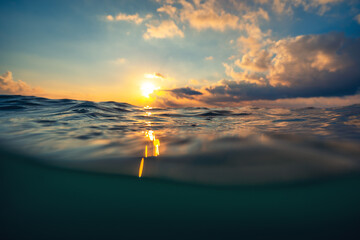 Wall Mural - sea wave close up, low angle view, sunrsie shot