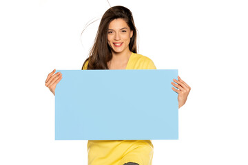 young beautiful happy woman holding a blue empty board