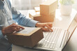 © ronstik - person preparing online store orders for shipping using laptop