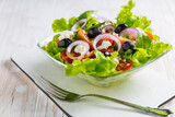 Fototapeta Tulipany - Greek salad with feta cheese, black olives and onion