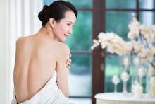 Rear View Of Young Woman Wrapped In Towel, Spa Center