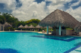 Fototapeta Sypialnia - Outdoor resort Swimming pool of luxury hotel in summer spa near the sea. Tropical Paradise. Dominican Republic, Seychelles, Caribbean, Bahamas.