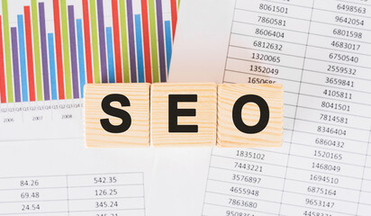 Poster - seo word written on wood block. faqs text on table, concept.