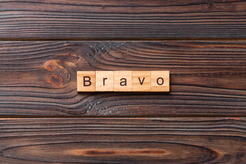 BRAVO word written on wood block. BRAVO text on cement table for your desing, concept