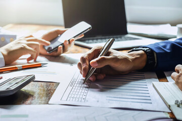 Fototapete - businessman working in office with using a calculator to calculate the numbers finance accounting concept