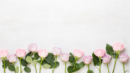 Wall Mural - Flowers valentine day composition. Frame made of pink rose on gray background. Flat lay, top view, copy space.