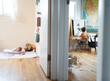© Maria Manco/Stocksy - child paints at easel while baby sleeps in next room