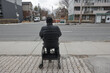 © JEFF WASSERMAN/Stocksy - Elderly Man Using Walker to Sit