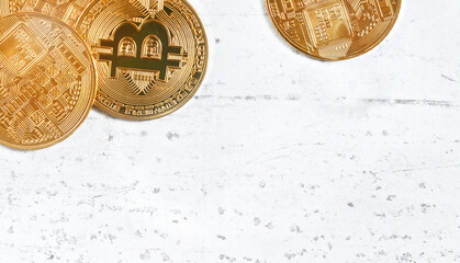 Top down view, golden commemorative btc - bitcoin cryptocurrency - coins on white stone board, closeup detail, space for text down right corner