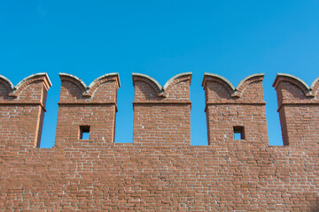 old city red brick fortress wall with windows for shooters