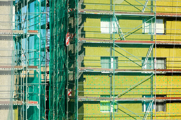 Wall Mural - scaffolding arround the house to install thermal insulation of the apartment building facade