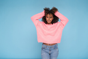 happy smiling afro girl in pink sweater