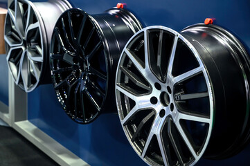 Alloy wheels are displayed in the shop.