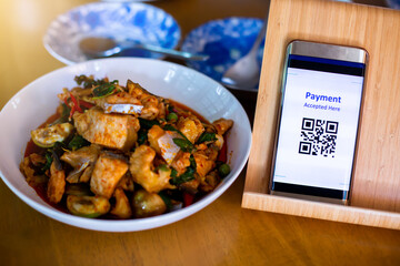 Wall Mural - QR code tag with blurry Asian food in restaurants to accepted generate digital pay without money. Qr code payment concept.