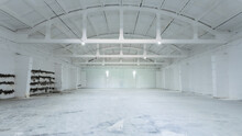 Industrial Building Interior With White Brick Walls, Concrete Floor And Empty Space For Product Display Or Industrial Background