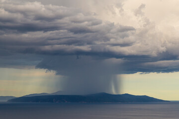 Dramatic storm scenery over the Adriatic Sea, with dark cumulus rain clouds