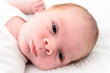 © boivinnicolas - Cute newborn baby boy face close up on a white blanket