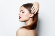 © SHOTPRIME STUDIO - Woman portrait Red lips bare shoulders straightens her hair with hand charm spa treatments