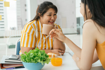 Wall Mural - Chubby woman enjoy eating healthy food for lunch with friend.