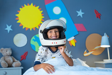 Wall Mural - Kid plays astronaut in his decorated bedroom