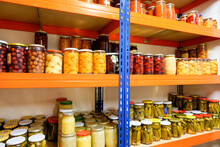 Shelf With Preserving Jars Containing Fruits And Vegetables