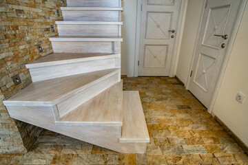 Sticker - Stylish wooden contemporary staircase inside loft house interior. Modern hallway with decorative limestone brick walls and white oak stairs.