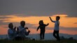 © MEDIAIMAG - Grandparent sit on hill and blow bubbles, children playing, sundown sky