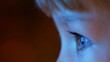 © MEDIAIMAG - Close of blue eyes child focus on tv, late night modern education, conceptual