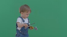 Little Baby Child With Coworker Overall Hold Screw Driver And Pliers, Dangerous Play, Green Screen