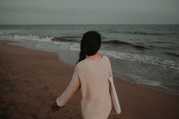 Girl enjoying the sea breeze on Maspalomas beach in the Canary Islands after sunset