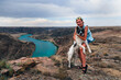 © Alex Sipeta - girl hugs a dog walking outdoors by a beautiful river