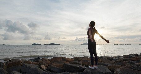 Wall Mural - Woman do yoga and sit beside the sea