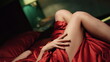 © stockbusters - Nude girl hands running along body in bed. Sensual woman lying red silk bed.