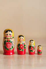 Wall Mural - Russian doll. matryoshka. four dolls stand on a beige background