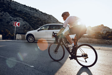 Wall Mural - Cycling sport athlete man riding on coastal road