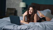© stockbusters - Girl greeting interlocutor laptop screen bed. Sexy woman relaxing with computer.