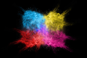 Wall Mural - Explosion of colored powder isolated on black background. 