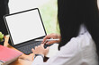 © Prathankarnpap - Cropped shot woman typing mockup digital tablet blank screen on work table.